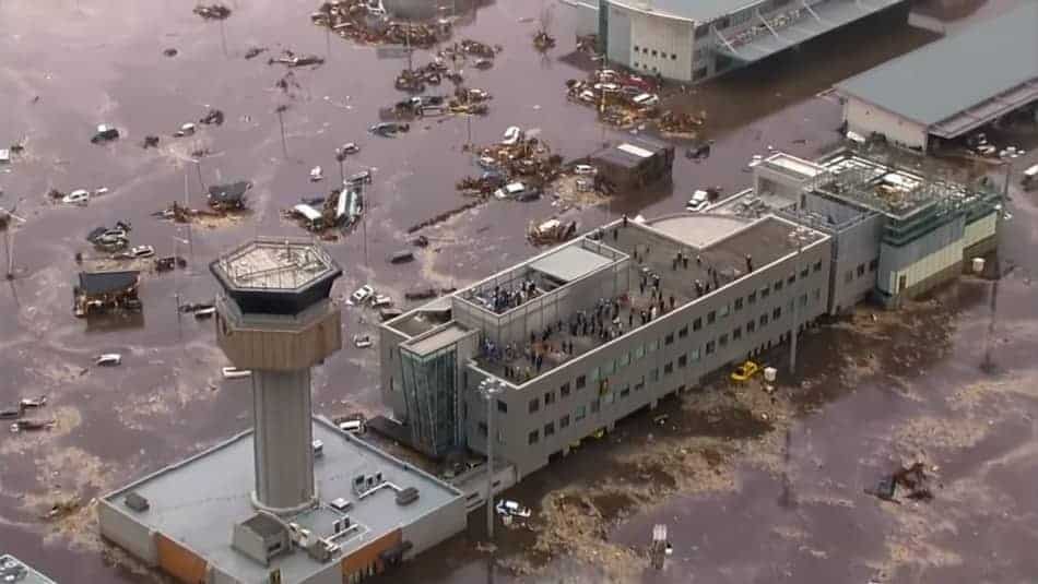 Helicopter photo of Fukushima Nuclear Power Plant flooded. People on the roof.