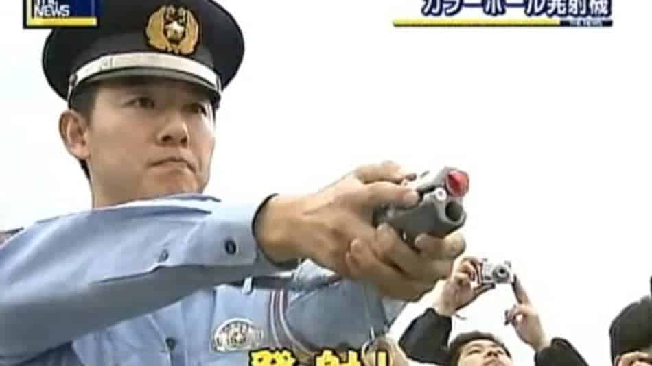Japanese police officer with paintball device