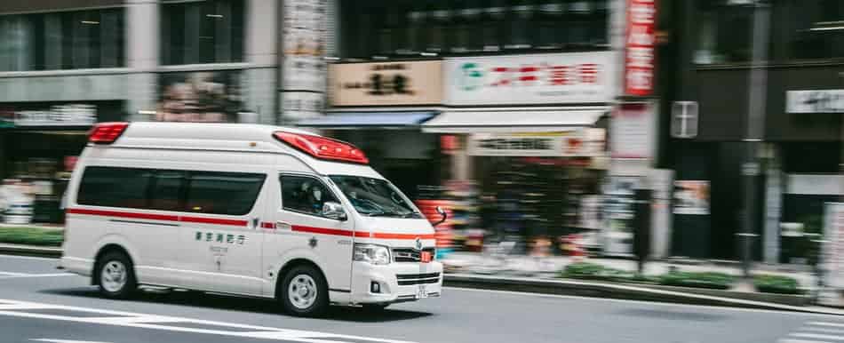 Tokyo ambulance driving on the road. What happens if you get sick in Japan?