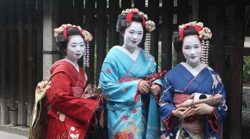 Three geishas posing for a picture