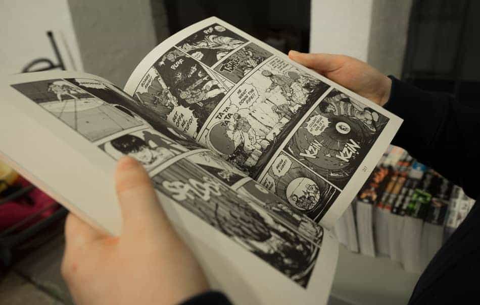Person reading a manga comic book